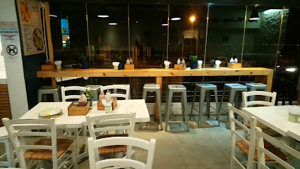 Lucky Fish & Chips Muizenberg interior with empty tables and counter seating