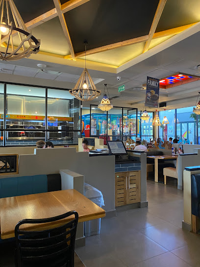Saratoga Spur interior with booths, pendant lights and seated diners