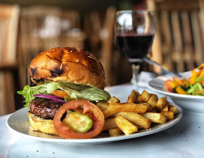 Only Fools pub burger with lettuce, tomato, fries and red wine