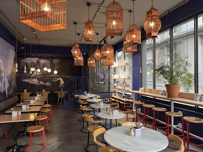 Swan Café interior with marble tables, bar seating and hanging lanterns