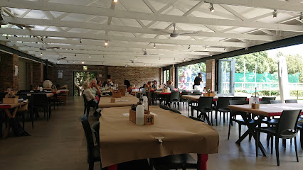 Clay Cafe Hout Bay interior with craft‑papered tables set for ceramic painting