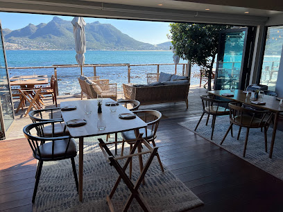 Dining tables facing ocean views at Chefs Warehouse Tintswalo Atlantic