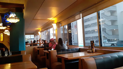 Rodeo Spur Halaal interior with leather booths, diners and city view through windows