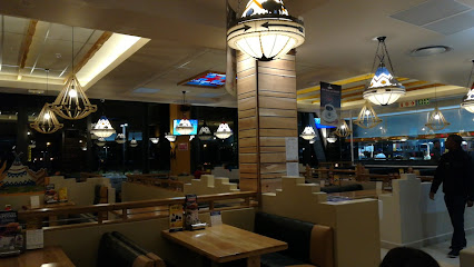 Cajun Spur restaurant interior with booth seating and hanging pendant lamps