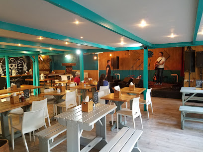 Cafe Roux Noordhoek dining room with a small live band on stage
