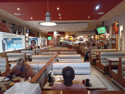 Panarottis N1 City interior — booth seating, counter and diners