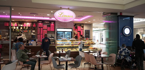 Limnos bakery counter with pastry display and seating in Somerset mall