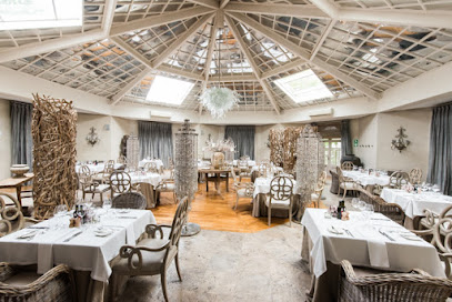 EAT Restaurant dining room with white-clothed tables beneath a glass dome
