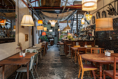 Pizza Warehouse at YARD interior with communal tables, bar, and hanging lamps