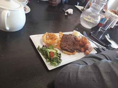 The Market Deli steak plate with salad, onion rings and potato bites