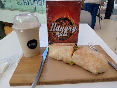 KAUAI smoothie cup and halved wrap on serving board at Tygervalley