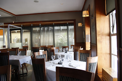 Cattle Baron Constantia dining room with white-tablecloth tables and wine glasses