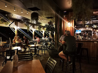 Fancy Frank's Somerset West dining area with patrons, bar and string lights