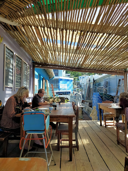Ohana Cafe shaded wooden patio with diners at communal tables