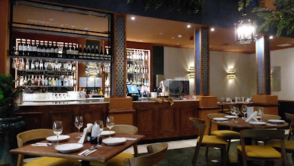 Thava Indian Restaurant GrandWest interior with set tables and bar
