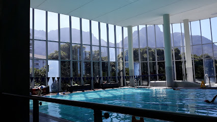 Kauai Virgin Active Claremont indoor pool with floor-to-ceiling windows and mountain view