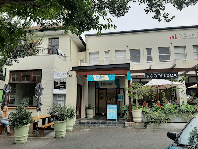 Kristen’s Ice Cream Newlands storefront with turquoise sign, outdoor seating, and neighboring NoodleBox