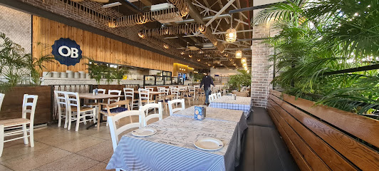 Ocean Basket V&A Waterfront dining area with blue-striped tablecloths and OB logo