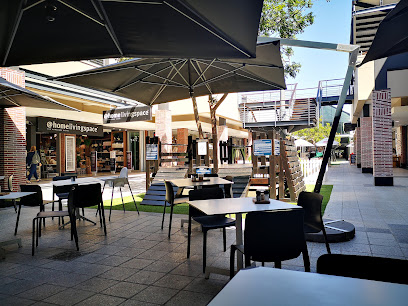 Woolworths Restaurant outdoor patio with tables, chairs and umbrellas