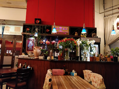 HeSheng Chinese Restaurant dining area with flower-adorned service counter