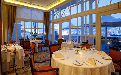Flint & Fennel dining room with neatly set tables and V&A Waterfront view