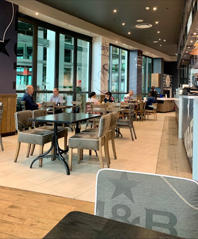 Mugg & Bean Milnerton cafe interior with diners and empty tables
