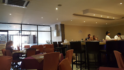 Yang Yang Chinese Restaurant & Sushi Bar dining room with seated patrons and staff