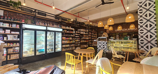 Off The Gluten Path Woodstock interior with shelves, refrigerated cases, counter and seating