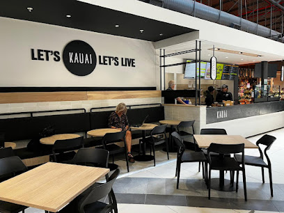 KAUAI Checkers Blue Route café counter and seating area with customer