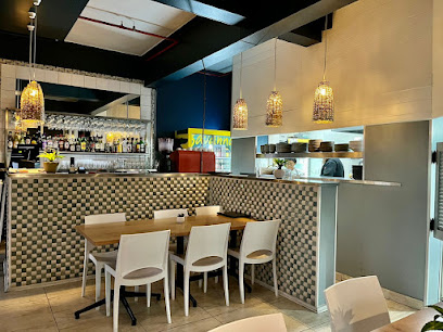 Salt and Lemon Sea Point interior with tables, bar and open kitchen
