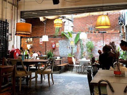 Pavement Cafe at YARD seating area with hanging lamps and plants
