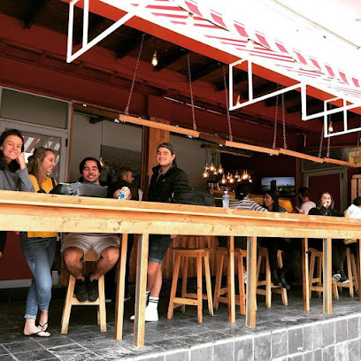 Customers seated at NY Slice Pizza Claremont open-air counter