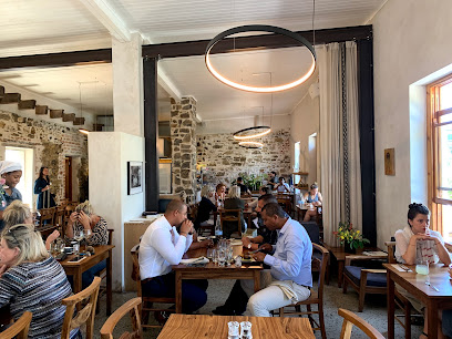 Between Us café interior with diners at wooden tables
