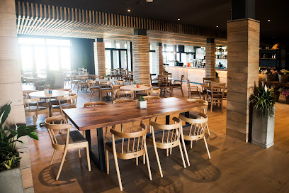 Milkwood Deli rustic dining area with communal wooden tables and chairs