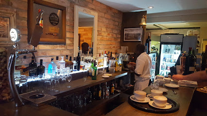 Rare Grill Kenilworth bar counter with bottles, a server and stacked cups