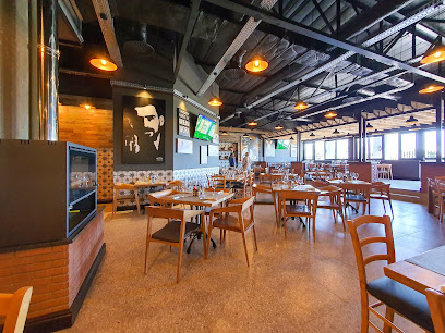 Bossa Sunningdale dining area with wooden tables, mural and pendant lights