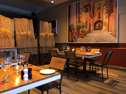 Cozy dining area at The Cousins Trattoria with set tables and Italian street mural