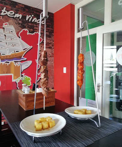 Skewers of grilled meat and chicken with fried potato cubes at Picado