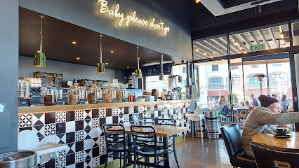 Bootlegger Durbanville café interior with tiled counter, seating, neon sign