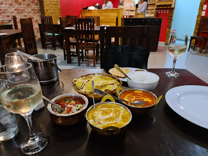 Ghodla's Tyger Waterfront table with curries, naan and wine
