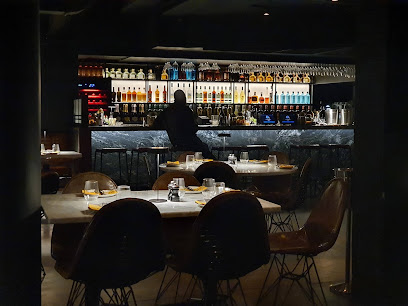Scala Pasta Bar interior with dim dining tables and backlit bar