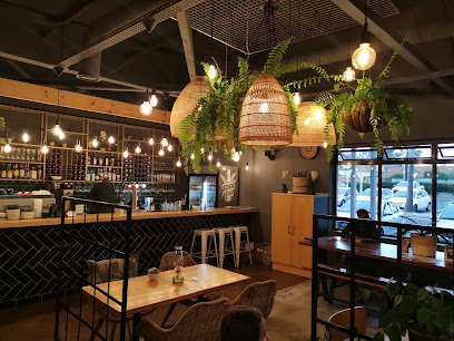 Reload Flamingo Square cafe interior with bar, hanging woven lamps
