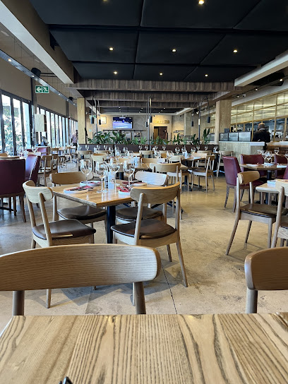 Turn ʼn Tender Steakhouse Majik Forest interior with set tables and wine glasses