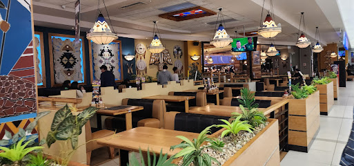 Topeka Spur Halaal Kenilworth dining area with booths and pendant lights
