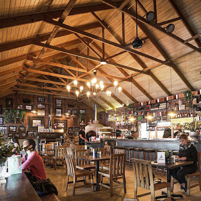 Fat Harry's rustic pub interior with bar, wooden beams, chandeliers and diners