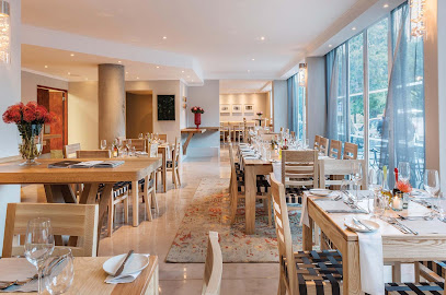 Eighty-Ate Restaurant dining room with set wooden tables and large windows