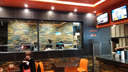 Bin Rashied Rylands dining area with open kitchen, orange chairs and customers