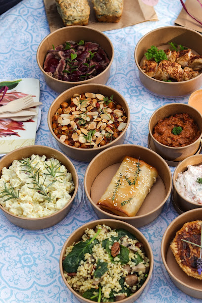 Protea Picnics curated picnic bowls with assorted salads and snacks on blue cloth