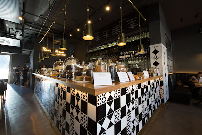 Bootlegger Kenilworth cafe counter with patterned tiles and cake displays