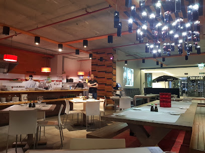 Active Sushi Buitenkant interior showing dining tables and sushi counter